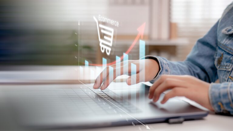 Hands,Typing,On,A,Laptop,With,An,Upward,Bar,Chart
