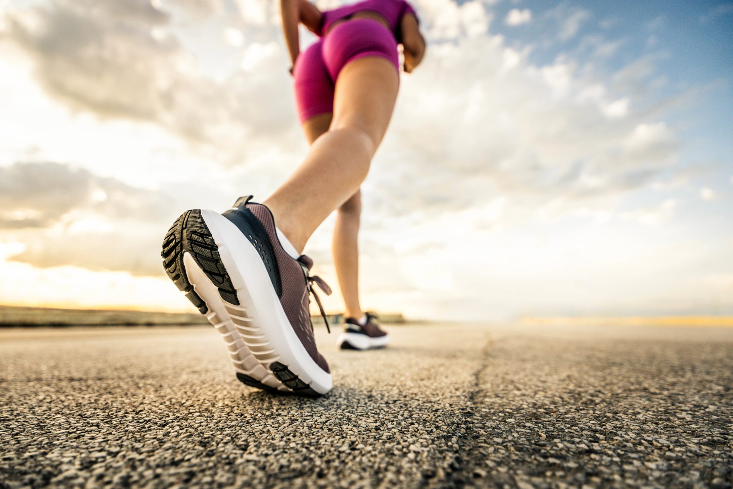 Runner,Woman,Feet,Running,On,Urban,Road,-,Fit,Female